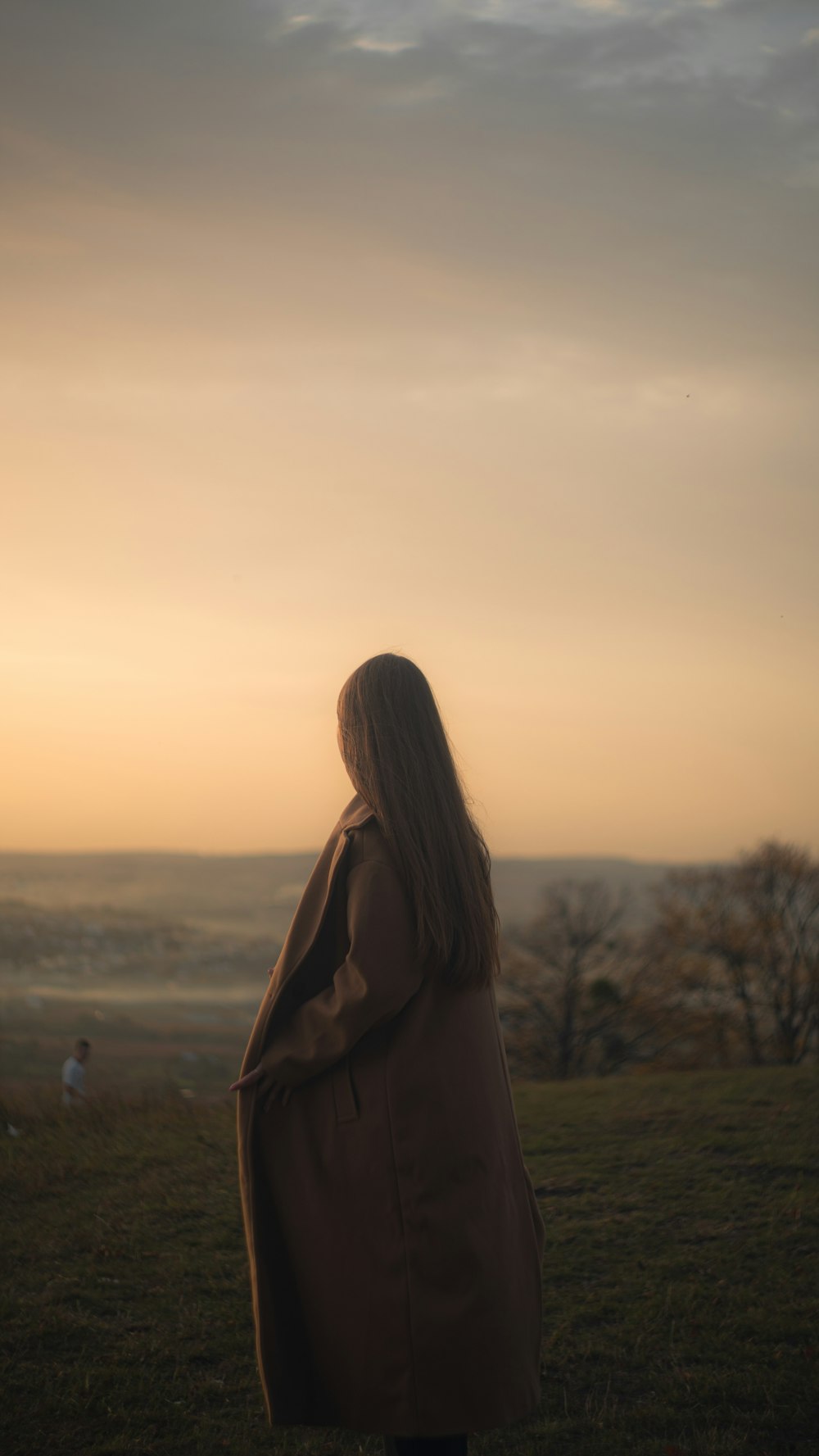 a woman standing on top of a lush green field