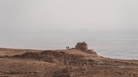 A private guide leading cyclists through rugged desert trails near Caldera.