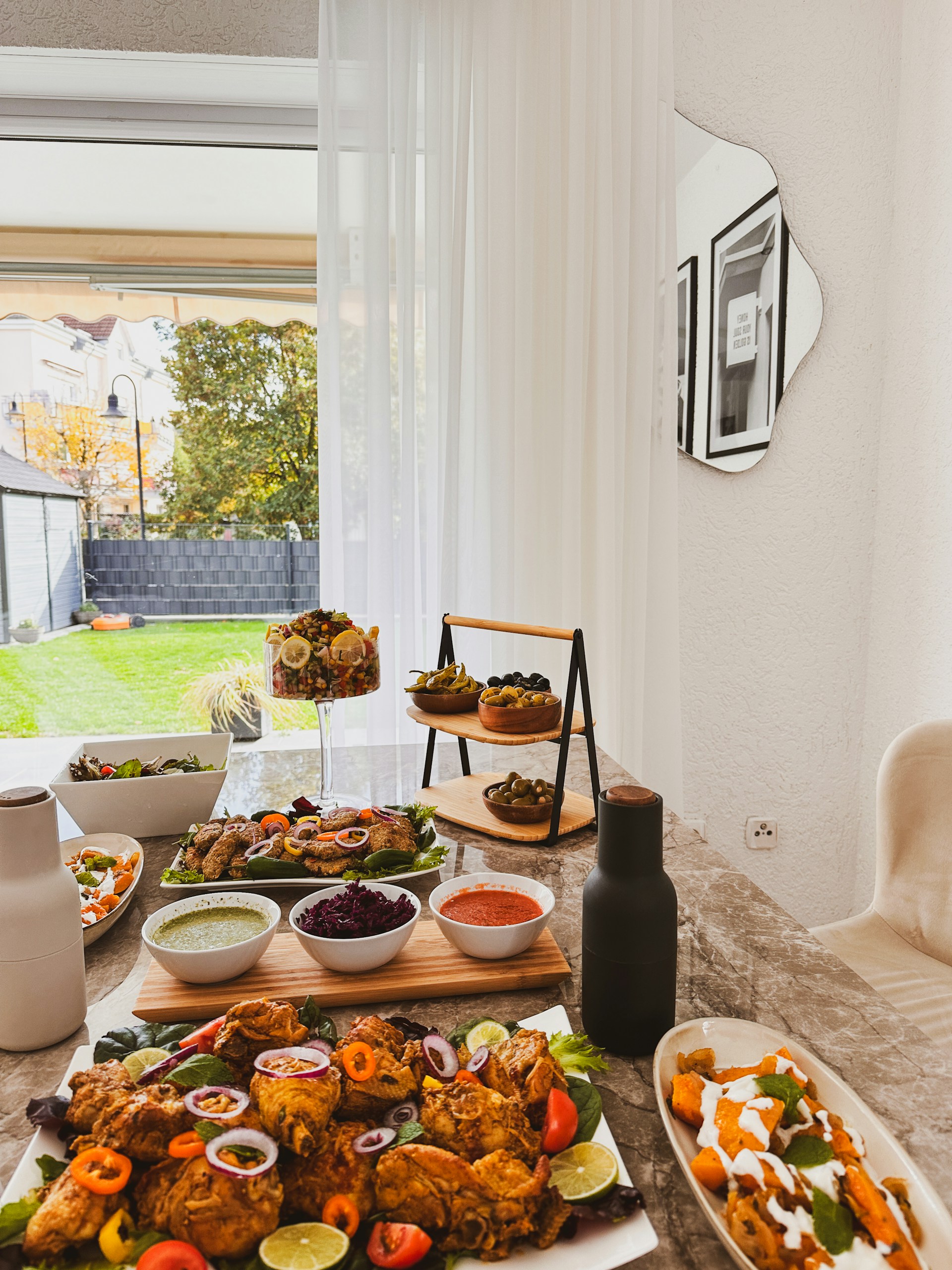 A beautifully set dining table featuring classic Southern dishes like fried chicken and collard greens.