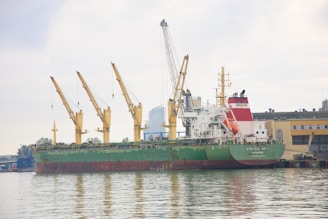 a large green and white ship in a body of water