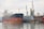 Wide view of a large cargo ship docked for repairs under clear skies.