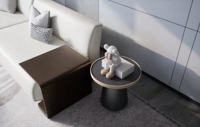 A folded table tucked neatly under a sofa in a modern living room, showcasing its space-saving design.