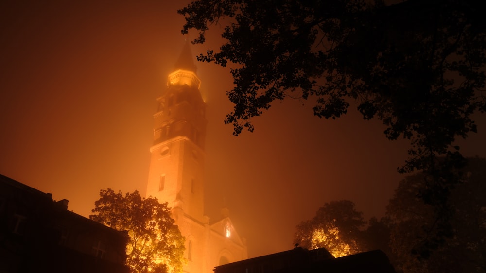 a tall clock tower towering over a city at night