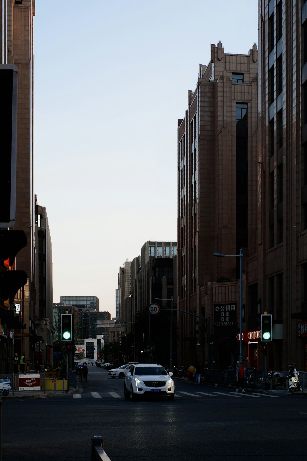 a city street filled with traffic next to tall buildings