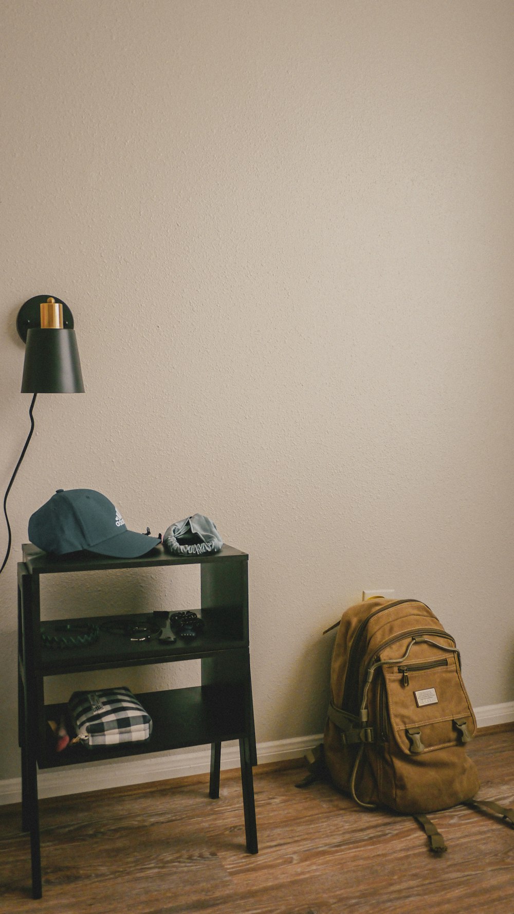 a room with a backpack and a lamp