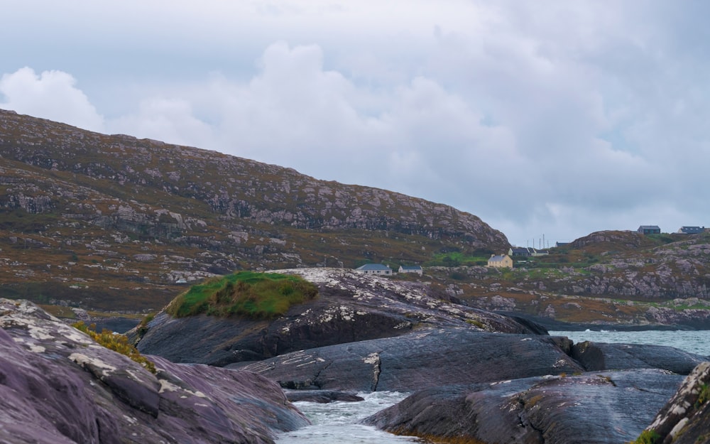 a stream running between two large rocks in the ocean