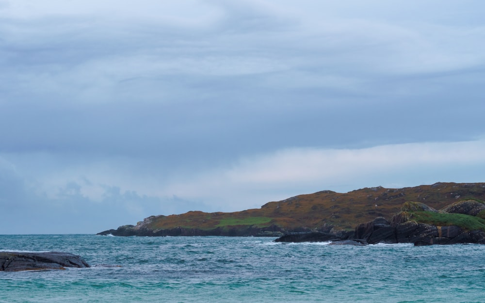 a large body of water with a small island in the background