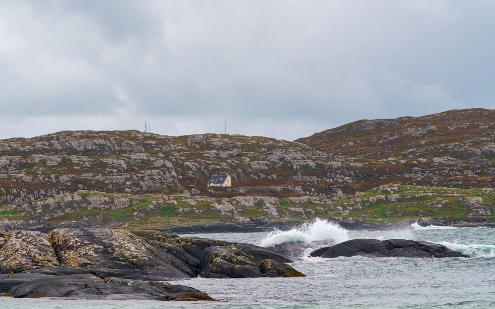 a large body of water next to a rocky shore