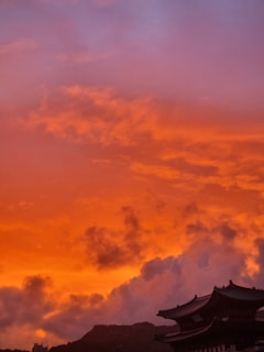 A dramatic aerial shot capturing the Marrakech skyline at sunset with vibrant colors.