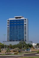 a very tall blue building sitting in the middle of a street