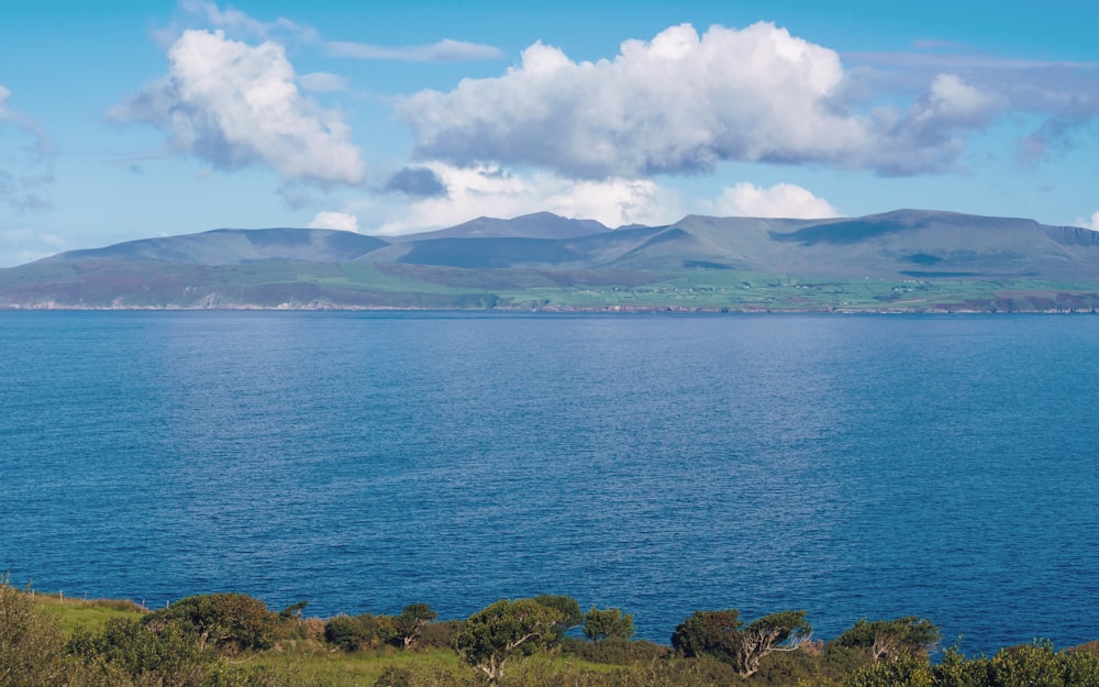 a large body of water with mountains in the background