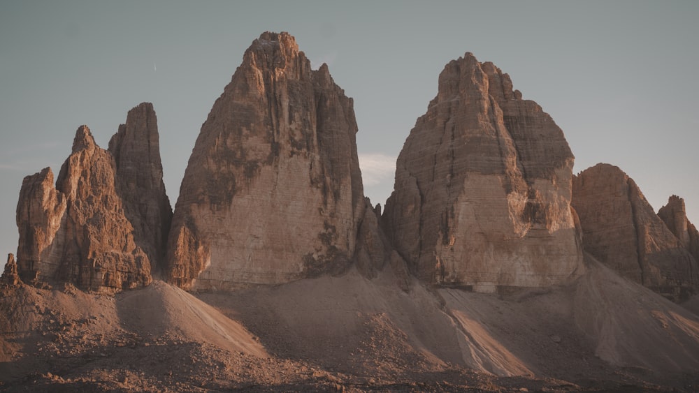 a group of tall rocks sitting in the middle of a desert