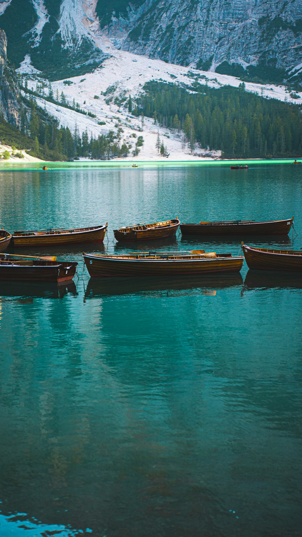 a group of boats floating on top of a lake