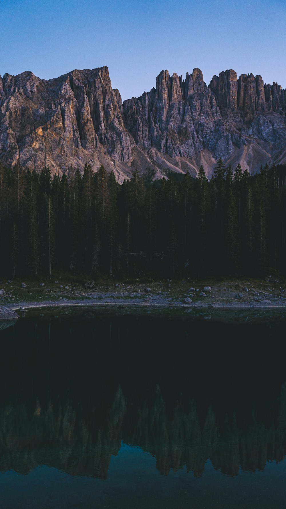 a mountain range with a lake in the foreground