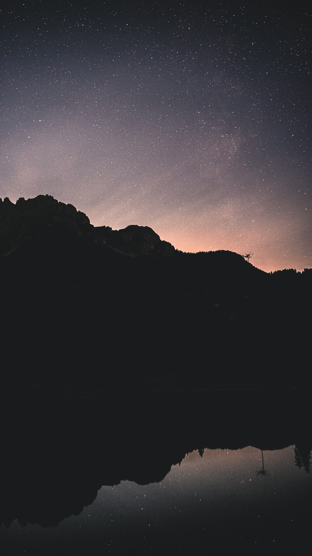 a mountain with a body of water in front of it