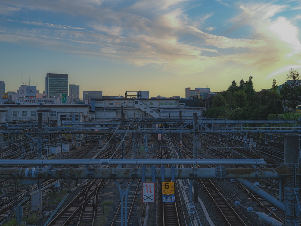 a view of a train yard with a sunset in the background