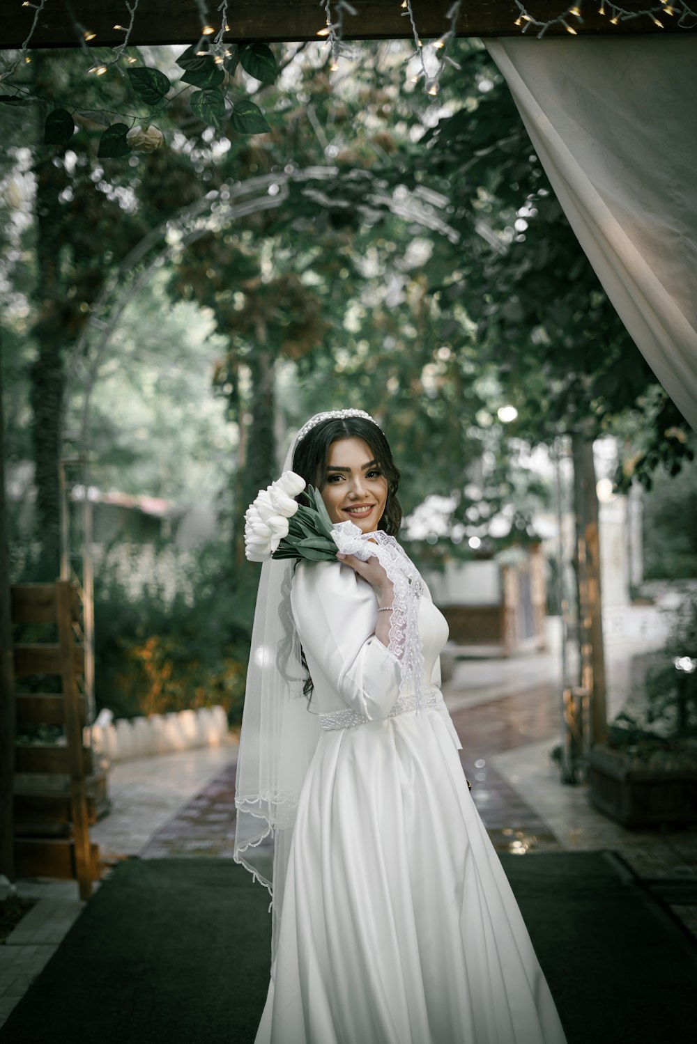 a woman in a wedding dress holding a flower