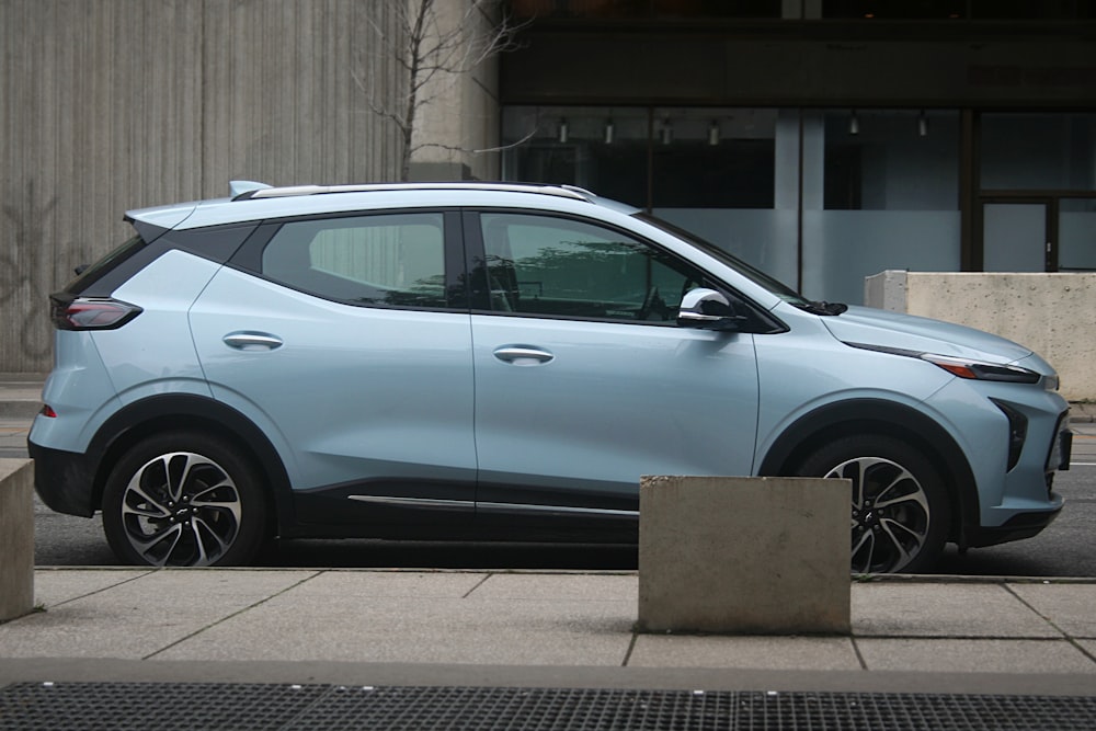 a blue car parked on the side of the road