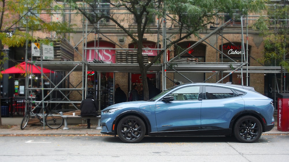 a blue car parked on the side of the road