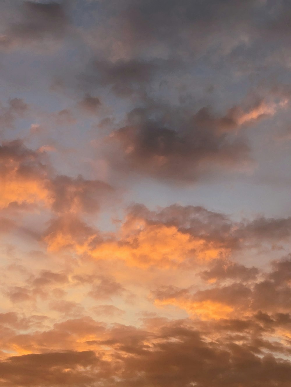 Un aereo che vola attraverso un cielo nuvoloso al tramonto