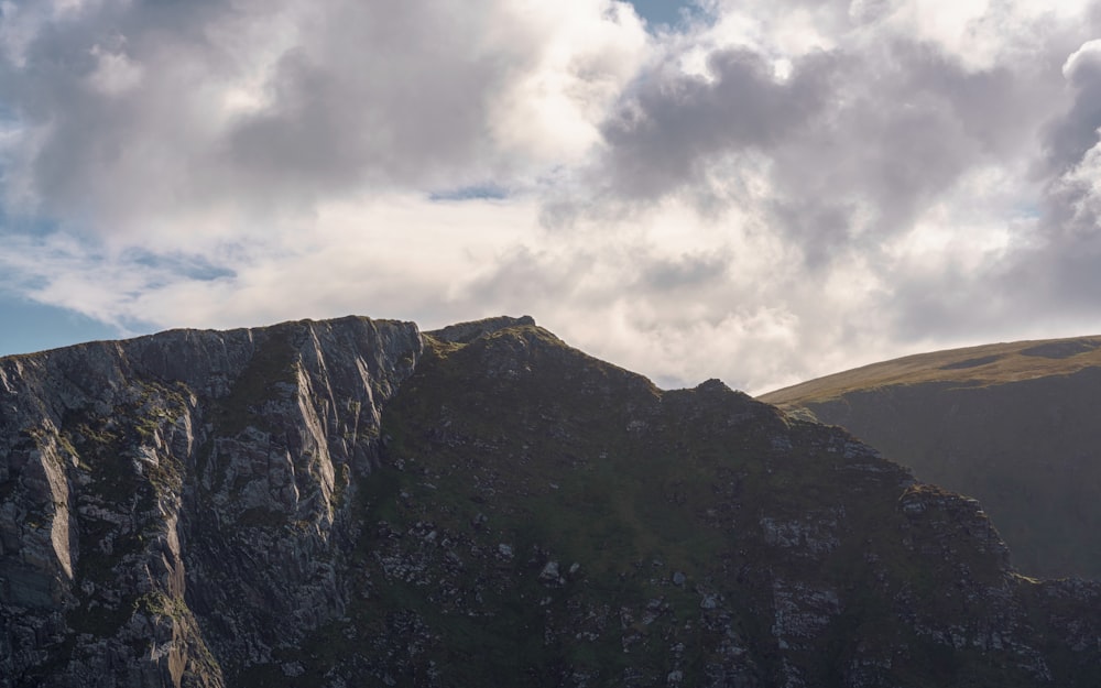 a view of a mountain with clouds in the sky