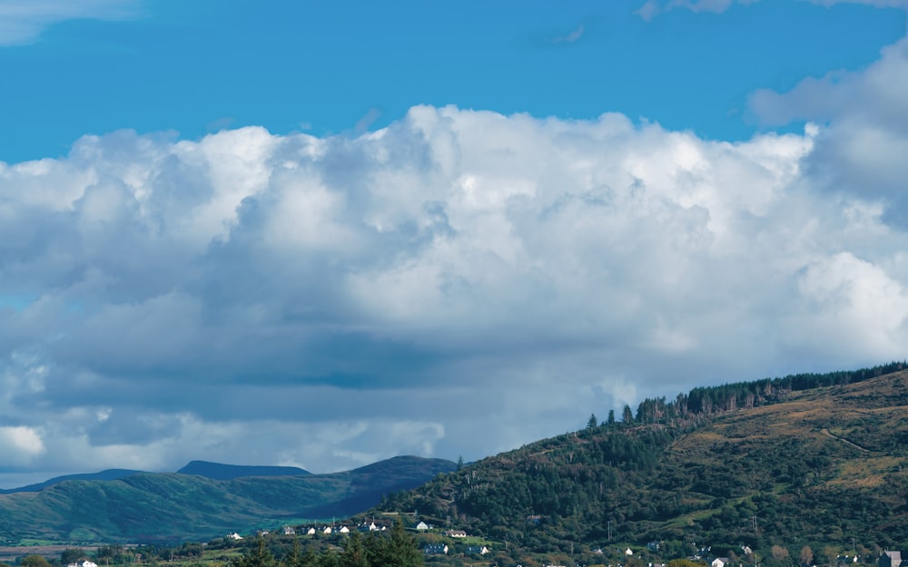 a view of a mountain range with clouds in the sky