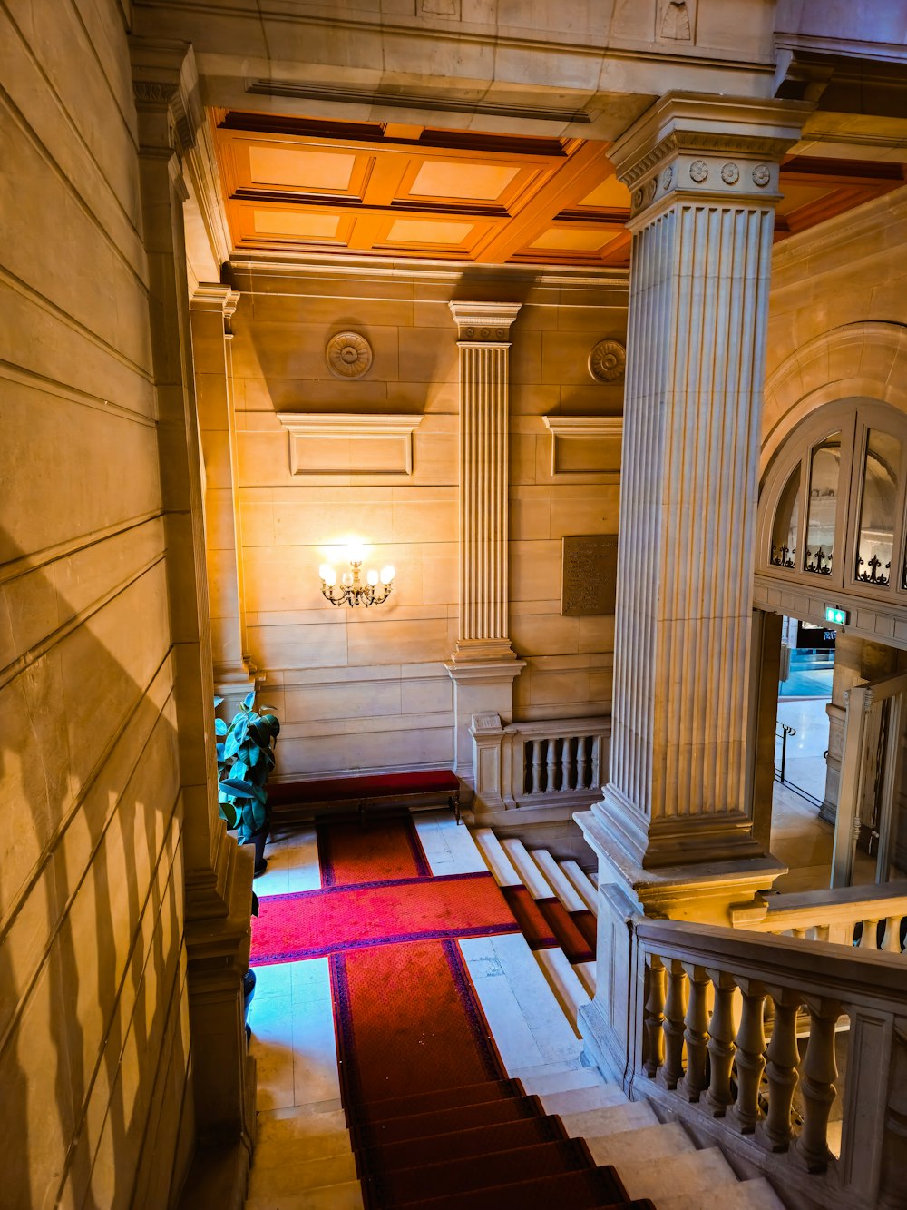 a staircase in a building with a red carpet