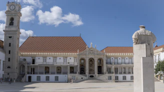 a large white building with a clock tower