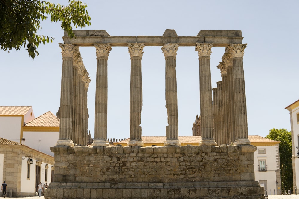 a large stone structure with four pillars on top of it