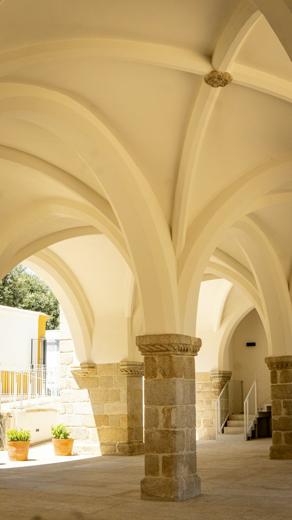 a building with arches and a clock on the wall