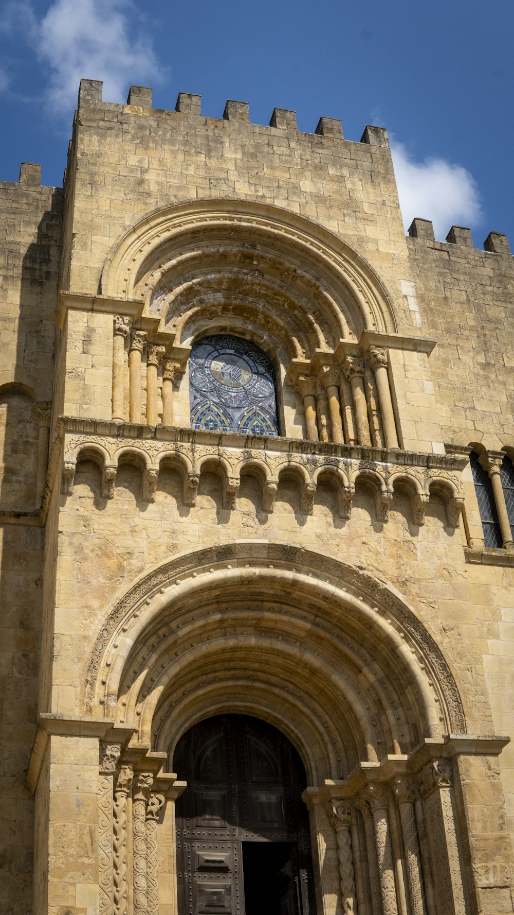 a large stone building with a clock on it's side