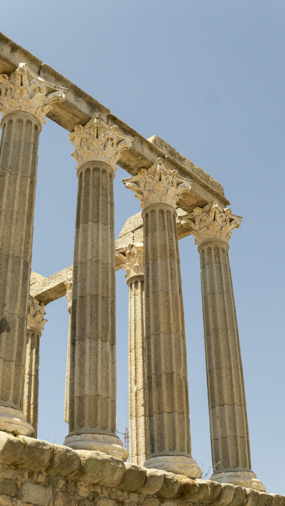 a stone structure with four pillars and a clock