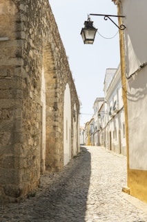 a cobblestone street with a light hanging over it