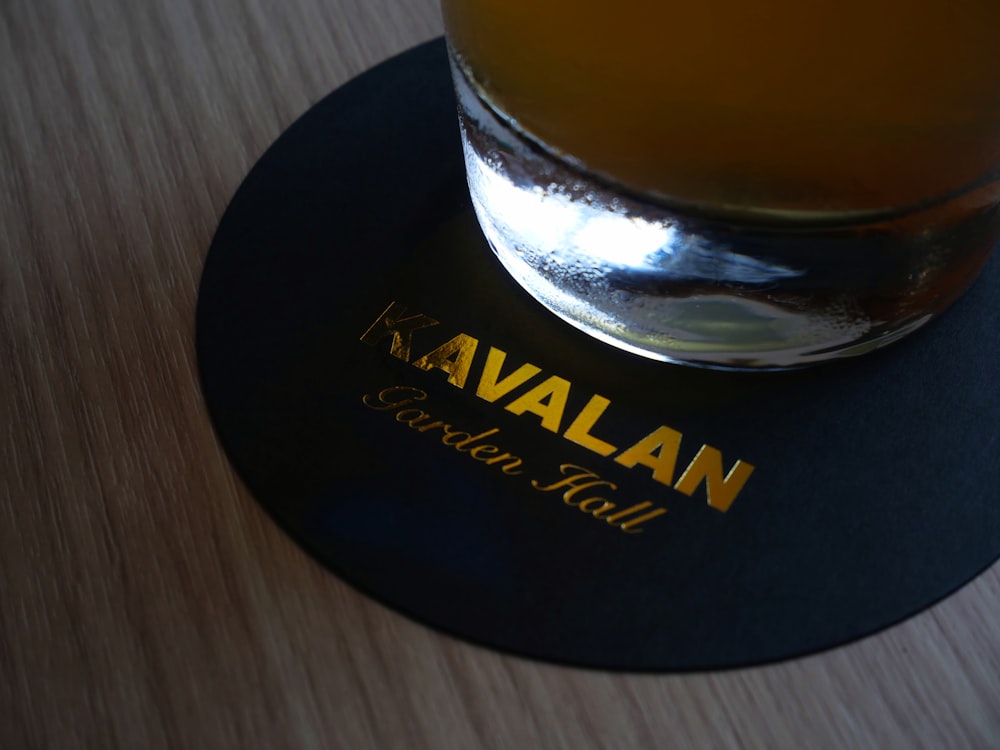 a glass of beer sitting on top of a wooden table