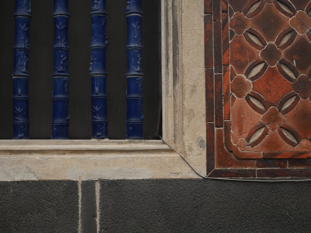 a cat is sitting on the ledge of a window