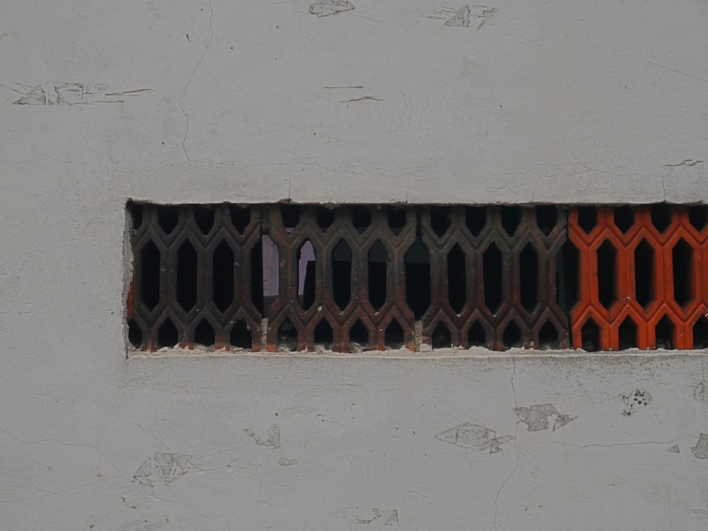 a close up of a metal grate on the side of a building