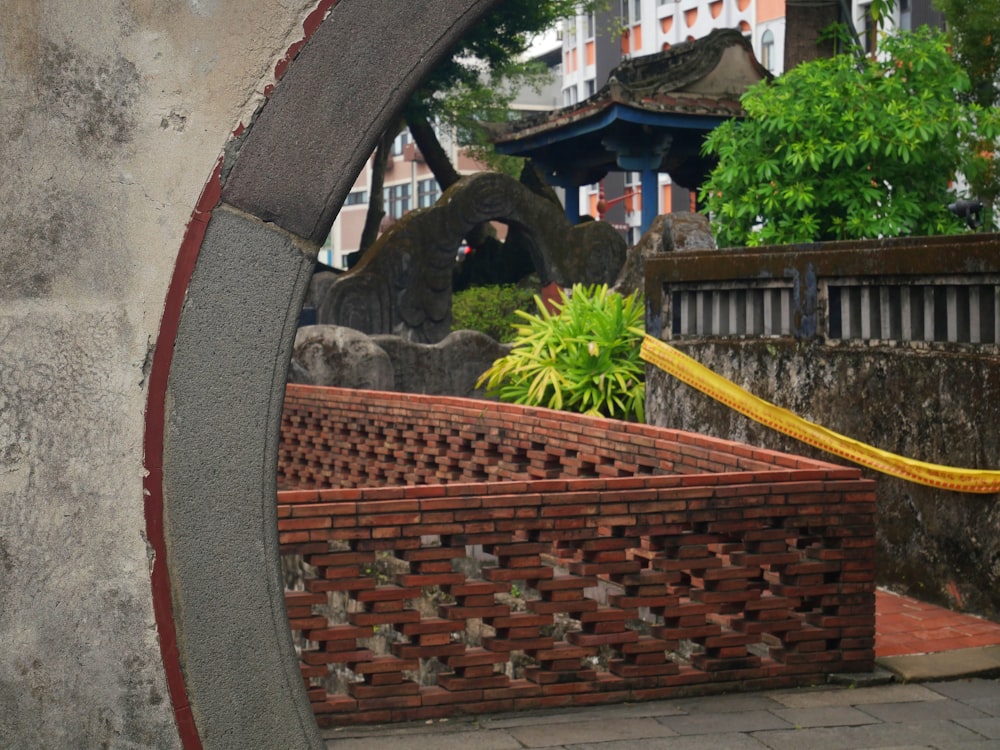 a brick wall with a yellow ribbon around it