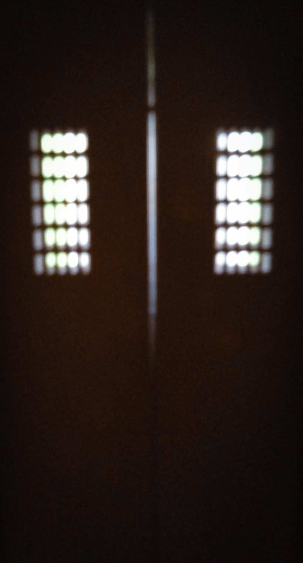 two open doors in a dark room with light coming through them