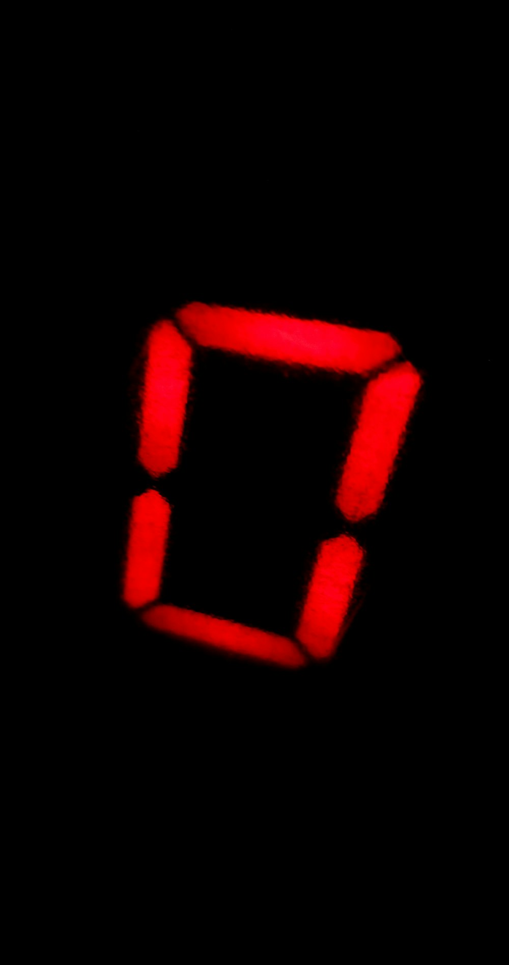 a red clock with a black background