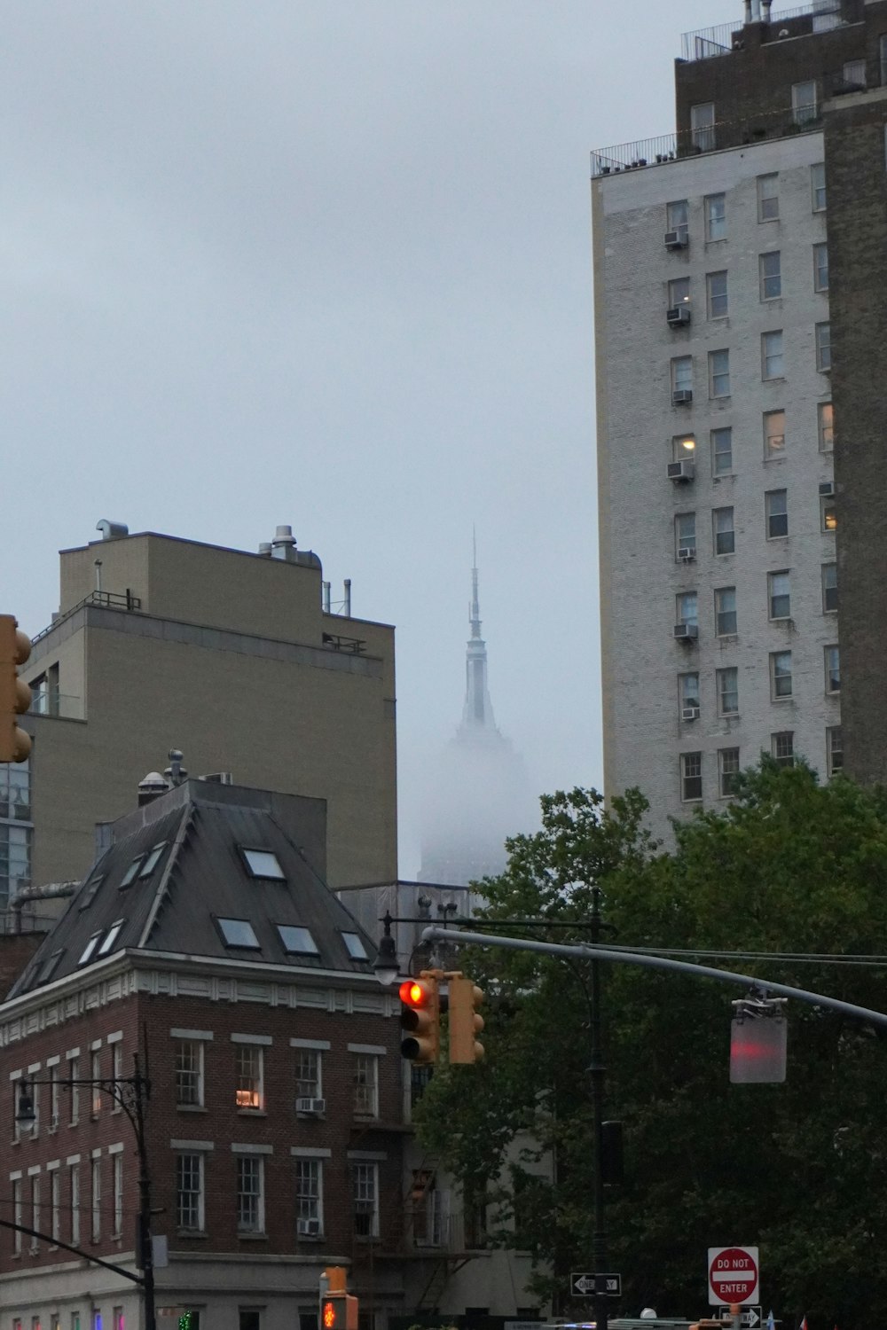 a traffic light on a city street with buildings in the background