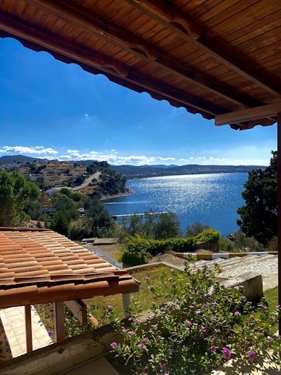 A sunlit coastal villa overlooking the sparkling Athenian sea on a bright summer day.