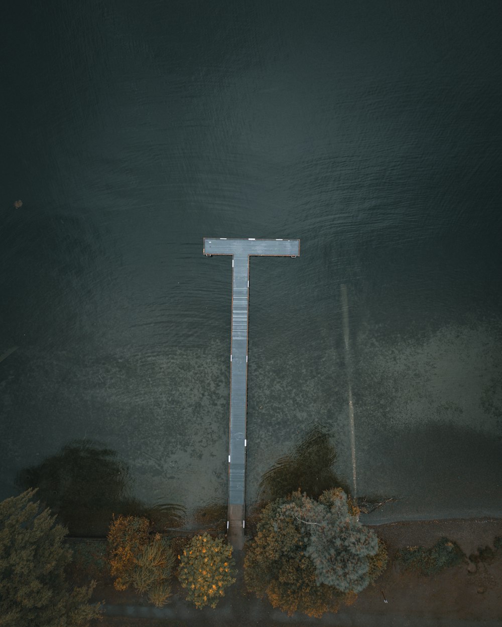 an aerial view of a cross in the water