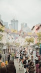 A candid street photograph of people enjoying a vibrant market in Hong Kong.