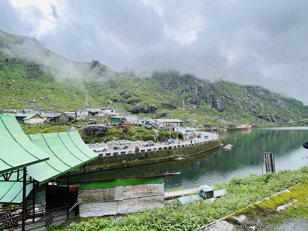 a body of water surrounded by a lush green hillside