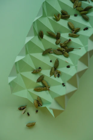 Neatly packed export-grade cardamom boxes with elegant green and gold branding.