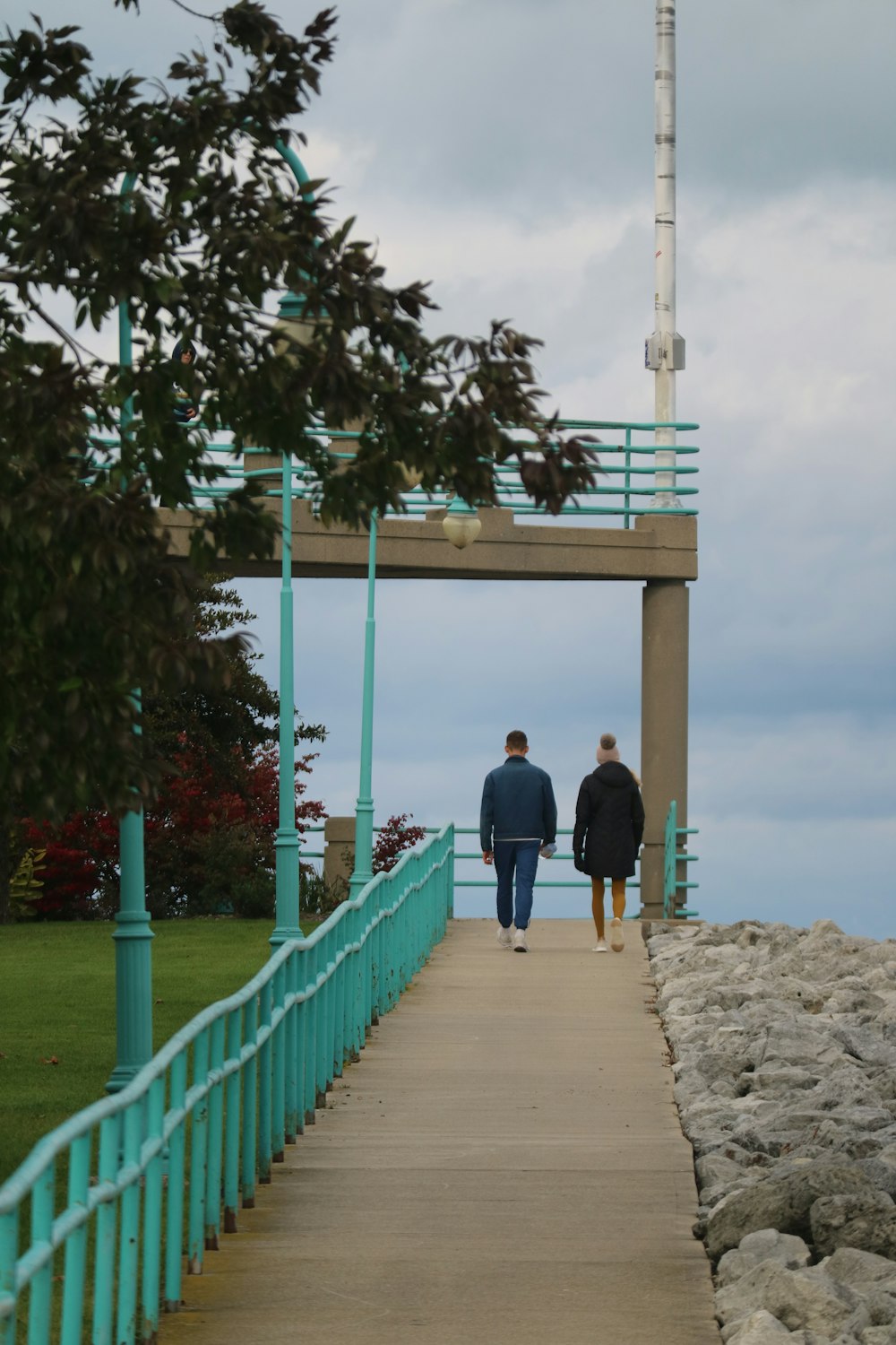 a couple of people walking down a walkway