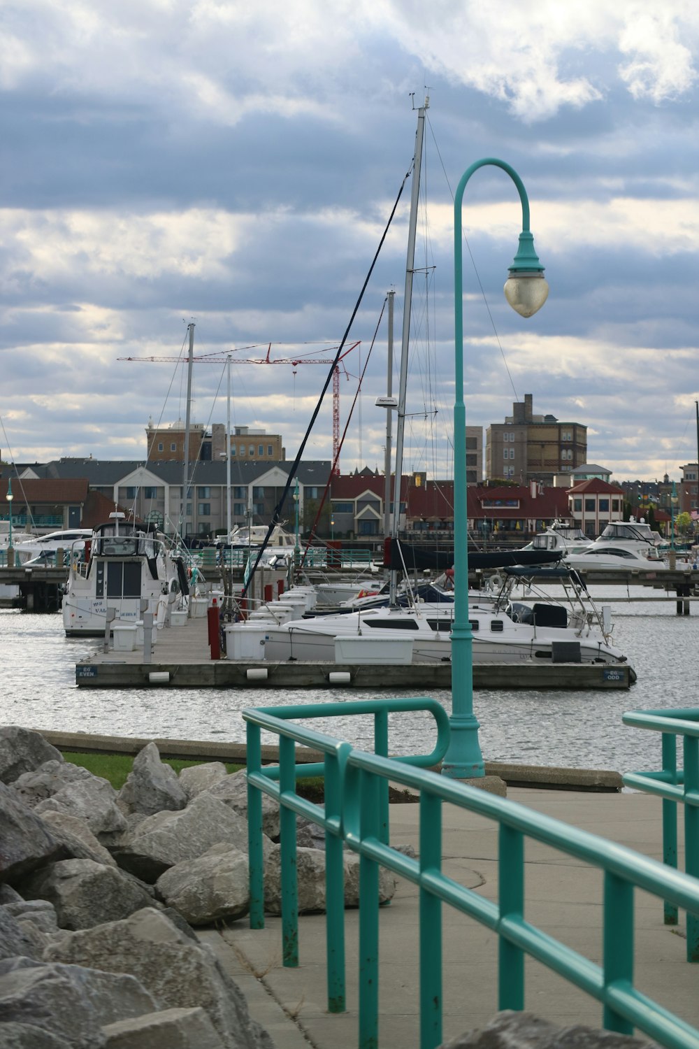 a harbor filled with lots of boats under a cloudy sky