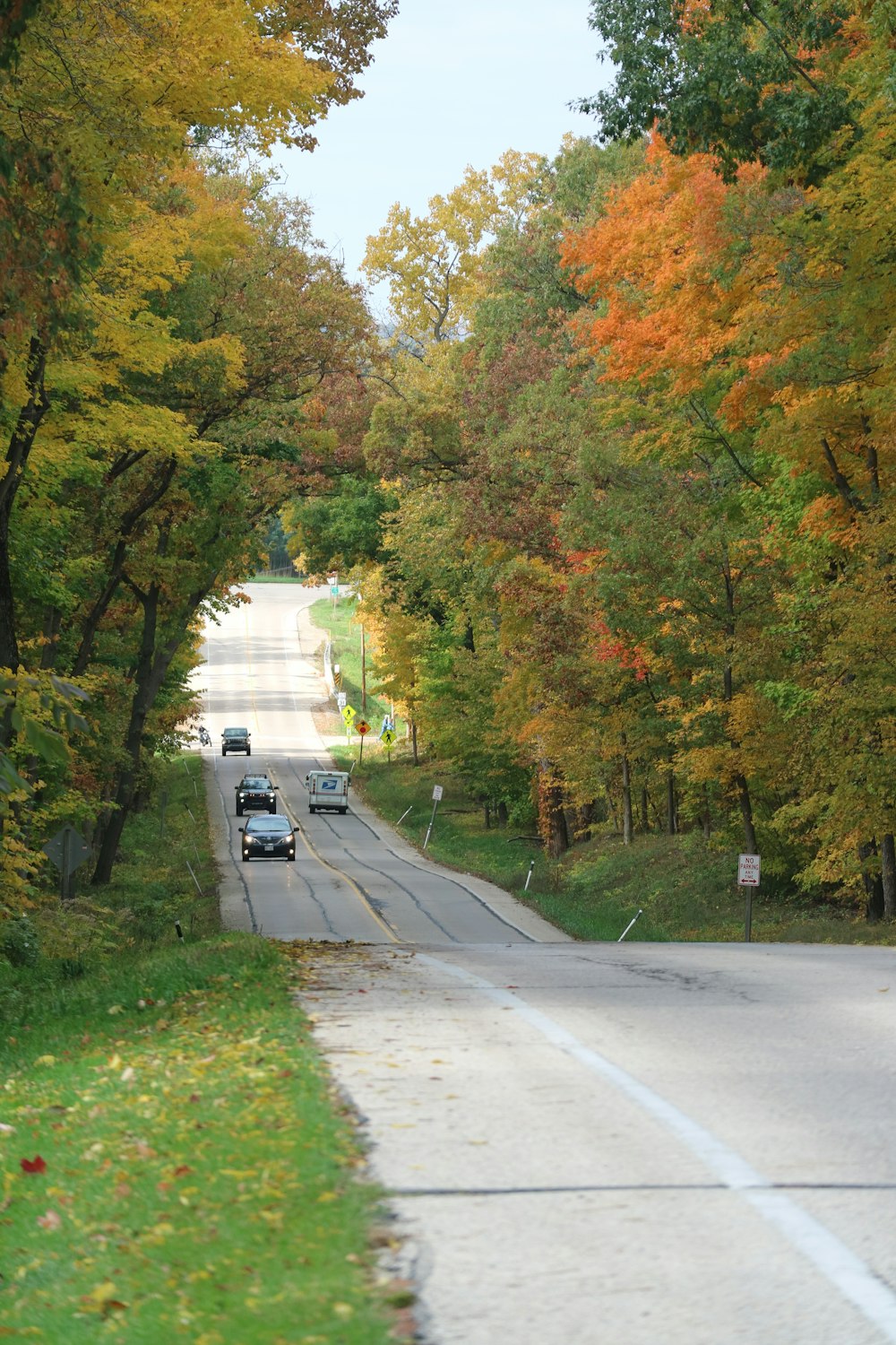 a couple of cars that are driving down a road