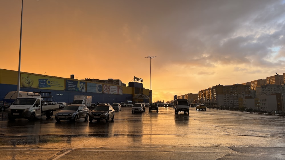 a city street filled with lots of traffic under a cloudy sky