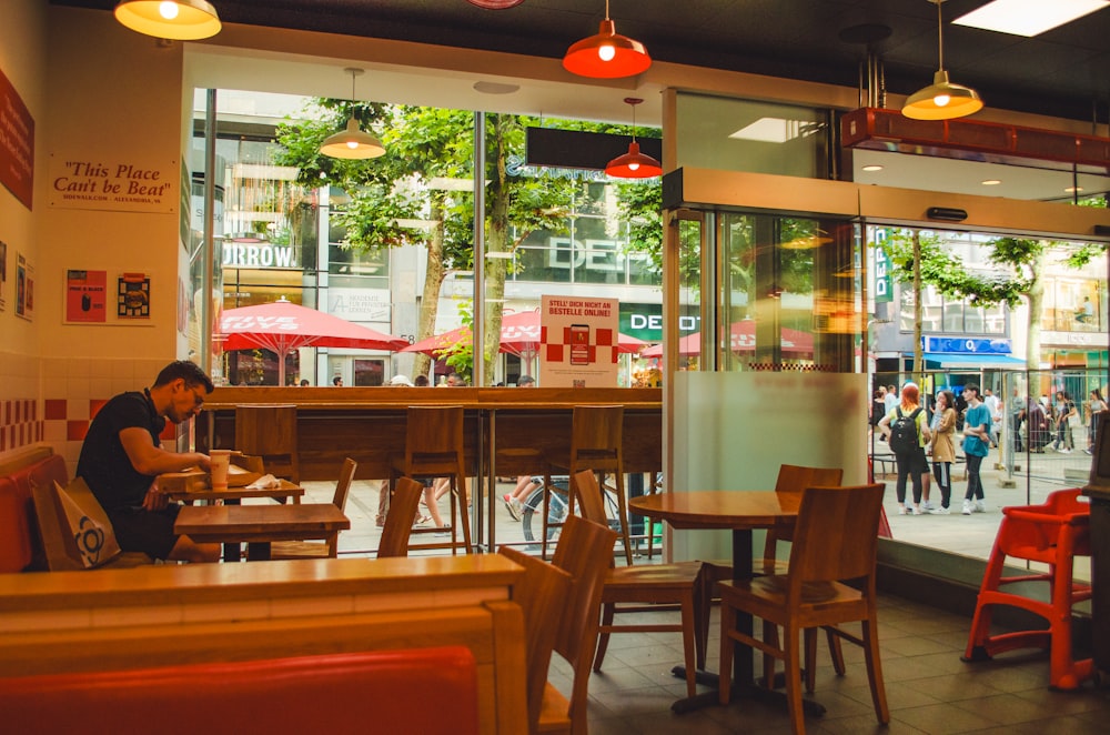 a person sitting at a table in a restaurant